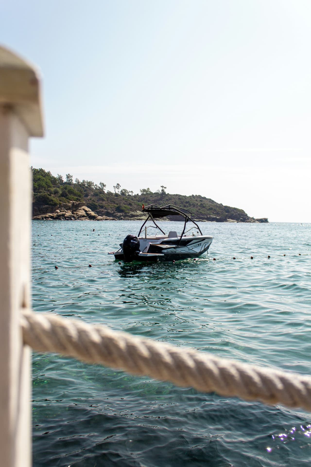 Een motorboot op het water, gezien vanaf een reling