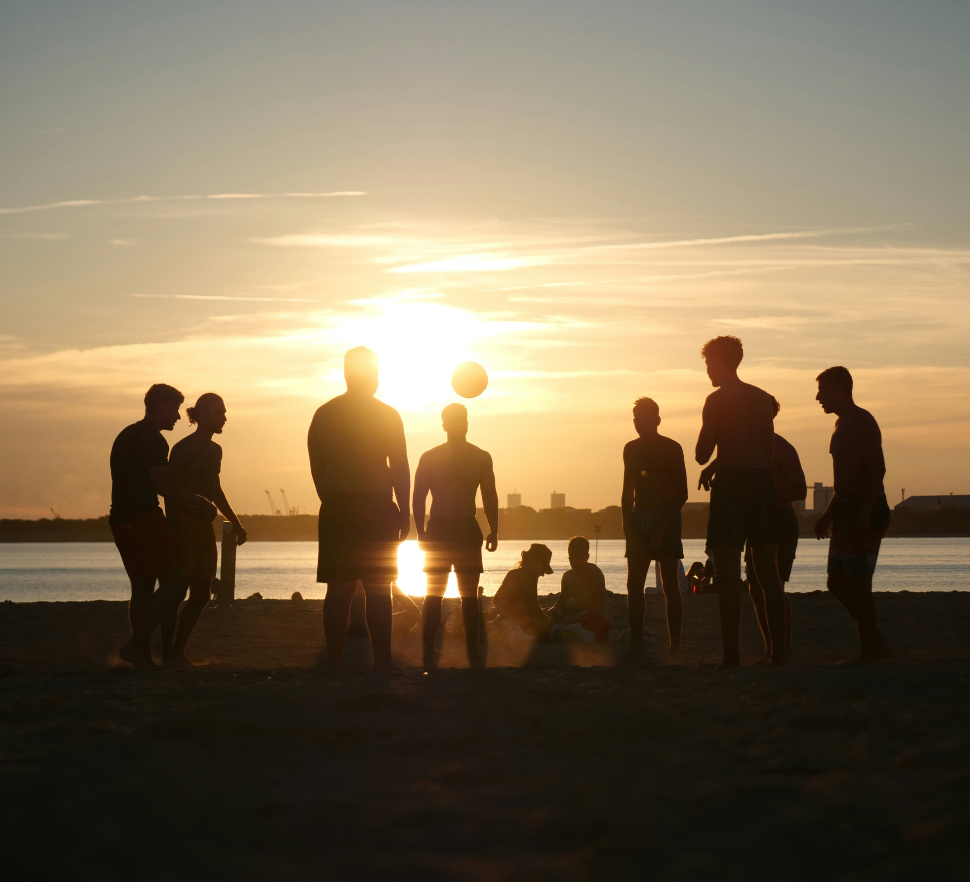 Community bij zonsondergang aan zee
